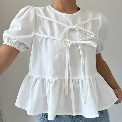 Dam Peplum Blus med Puffärmar och Rosett-detaljer – Romantisk och Modern Top för Vardag och Fritid